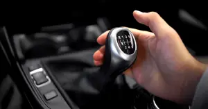 person using gear shift to change gears