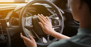 woman in car honking horn inside steering wheel