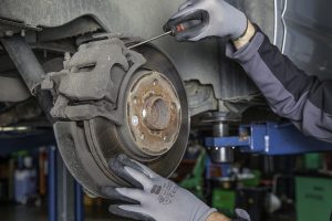 man working on brake disc in workshop