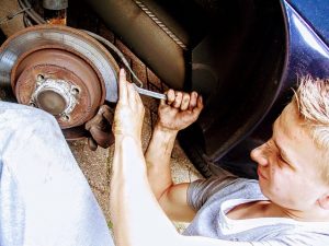 car mechanic repairing brake disc