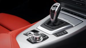 grey and black gear shift inside of car with red interior