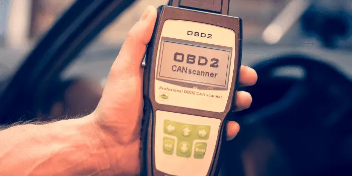 person holding OBDII Reader Device