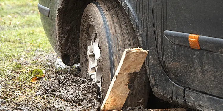  wood or rocks behind wheel to get out of mud