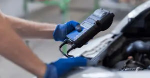 mechanic using obd scanner on vehicle