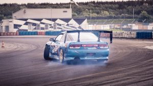 race car drifting on speedway track